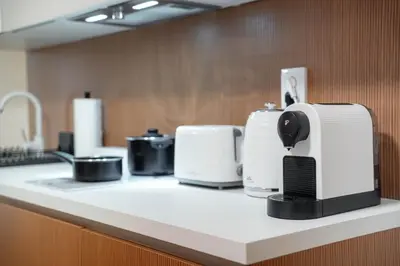 a kitchen counter with several toasters and appliances on it at Kajetanka Residence - with free weekend parking in Prague