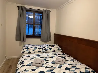 a bedroom with a bed with two pillows and a window at Balbín Central Apartment in Prague