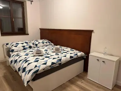 a bedroom with a bed with a black and white comforter at Balbín Central Apartment in Prague