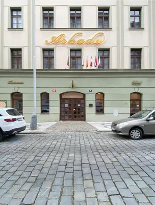 a building with two cars parked in front of it at Balbín Central Apartment in Prague