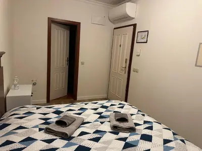 a bedroom with a bed with towels on it at Balbín Central Apartment in Prague