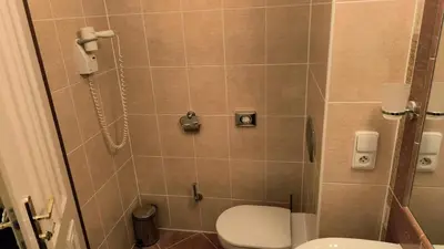 a bathroom with a toilet and a shower at Balbín Central Apartment in Prague