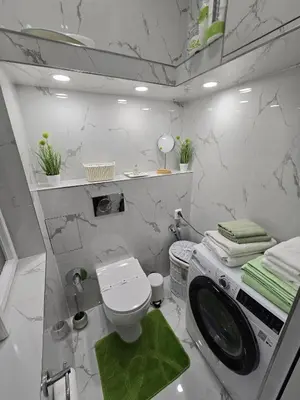 a white bathroom with a toilet and a sink at Get Prague Flat Trojanova in Prague
