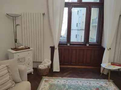a living room with a couch and a window at Get Prague Flat Trojanova in Prague