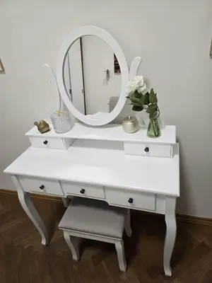 a white desk with a mirror and a vase of flowers at Get Prague Flat Trojanova in Prague