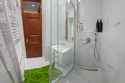 a bathroom with a shower and a sink at Get Prague Flat Trojanova in Prague