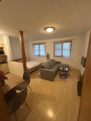 a living room with a couch and a bed at Eleven Břevnov in Prague