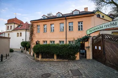a large brick building with a gate in front of it at Romantic Apt with Secret Terrace - Old Town Prague in Prague