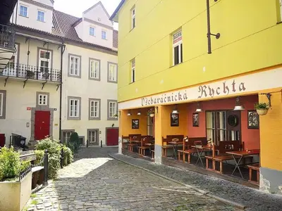 a group of buildings with tables and chairs on a street at Romantic Apt with Secret Terrace - Old Town Prague in Prague