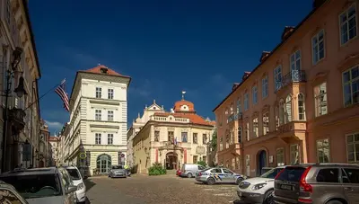 a city street with cars parked in front of buildings at Romantic Apt with Secret Terrace - Old Town Prague in Prague
