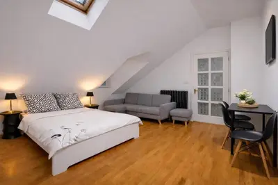 a bedroom with a bed and a couch and a desk at Romantic Apt with Secret Terrace - Old Town Prague in Prague