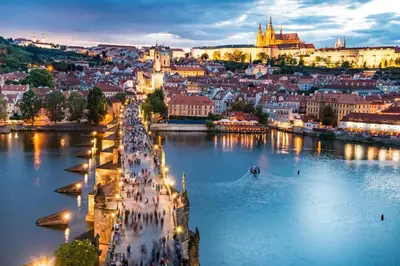 a view of a city from the river at night at Romantic Apt with Secret Terrace - Old Town Prague in Prague