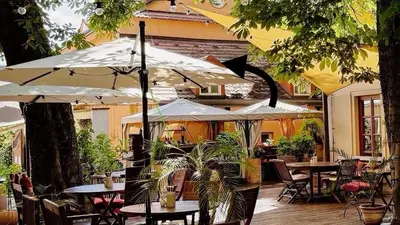 a patio with tables and chairs with umbrellas at Romantic Apt with Secret Terrace - Old Town Prague in Prague