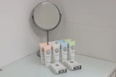 a mirror and a bunch of toiletries on a counter at Modern City Apartment in Prague