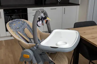 a baby car seat sitting next to a table at Modern City Apartment in Prague
