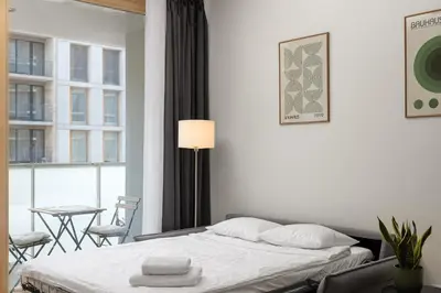 a bedroom with a bed and a table and chairs at Modern City Apartment in Prague