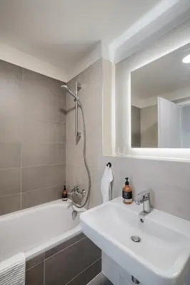 a bathroom with a sink and a tub and a shower at New Modern Apartment with Parking, near Airport in Prague