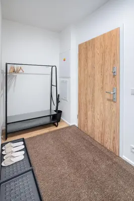 a room with a treadmill next to a door at New Modern Apartment with Parking, near Airport in Prague