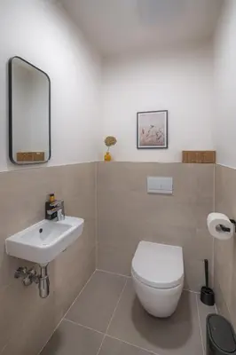 a bathroom with a white toilet and a sink at New Modern Apartment with Parking, near Airport in Prague