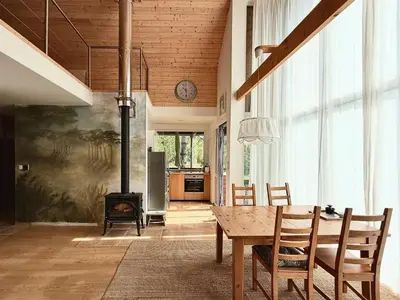 a kitchen and dining room with a table and a fireplace at 4borovice in Velká Lečice
