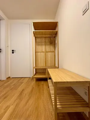 a room with a wooden table and a closet at Prague Anděl Quiet Comfy apartment in Prague