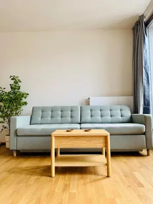 a living room with a blue couch and a coffee table at Prague Anděl Quiet Comfy apartment in Prague