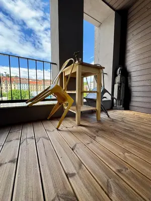 a yellow bench on a balcony with a window at Prague Anděl Quiet Comfy apartment in Prague