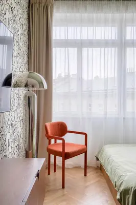 a bedroom with a chair and a bed and a window at Boutique Studio just 5 min from Wenceslas Square by Gravity Prague in Prague