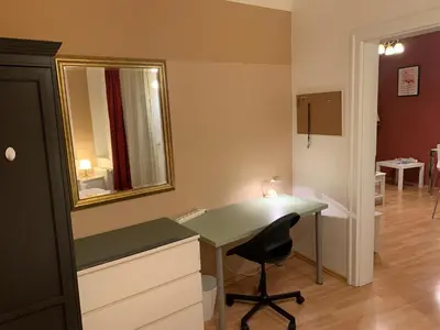 a room with a desk with a mirror and a chair at Palladium family apartment in Prague