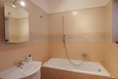 a bathroom with a tub and a sink and a shower at Palladium family apartment in Prague