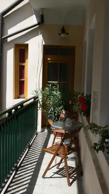 a patio with a table and chairs on a balcony at Palladium family apartment in Prague