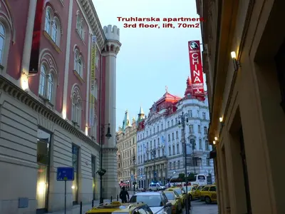 a city street with buildings and cars parked on the street at Palladium family apartment in Prague