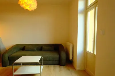 a living room with a couch and a table at ChlumovaNest Apartment in Žižkov, close to the city center in Prague