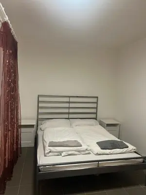 a bed with two pillows on it in a room at Big apartment in Brandýs nad Labem in Brandýs nad Labem-Stará Boleslav