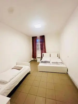 two beds in a room with a window at Big apartment in Brandýs nad Labem in Brandýs nad Labem-Stará Boleslav