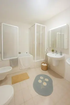 a white bathroom with a sink and a tub and a toilet at Villa with swimming pool near Prague in Kamenice
