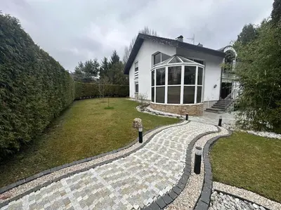a person standing in front of a house at Villa with swimming pool near Prague in Kamenice