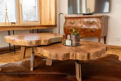 a room with two wooden tables and a dresser at Luxury Design Apartment Palackého Residence in Prague