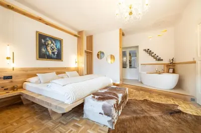 a bedroom with a bed and a tub and a sink at Luxury Design Apartment Palackého Residence in Prague