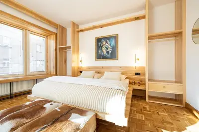 a bedroom with a king sized bed and windows at Luxury Design Apartment Palackého Residence in Prague