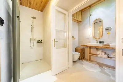 a bathroom with a shower and a toilet and a sink at Luxury Design Apartment Palackého Residence in Prague