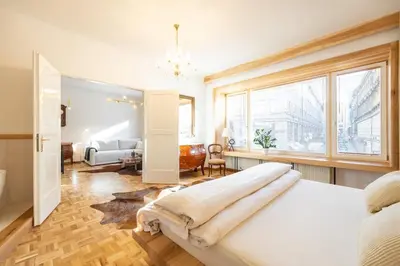 a bedroom with a bed and a large window at Luxury Design Apartment Palackého Residence in Prague