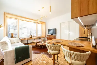 a kitchen and living room with a table and chairs at Luxury Design Apartment Palackého Residence in Prague