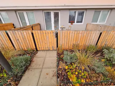 a wooden fence in front of a house at PRIVATE GARDEN 2BR PRAGUE APARTMENT for Business & Leisure, FREE PARKING & Gym, by LIVE-INN 2 in Prague