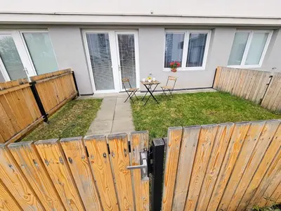 a backyard with a fence and a table with chairs at PRIVATE GARDEN 2BR PRAGUE APARTMENT for Business & Leisure, FREE PARKING & Gym, by LIVE-INN 2 in Prague
