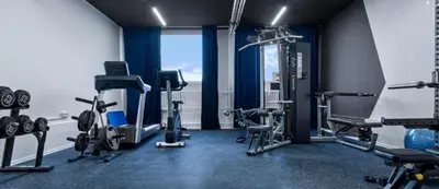 a gym with several tread machines and a window at PRIVATE GARDEN 2BR PRAGUE APARTMENT for Business & Leisure, FREE PARKING & Gym, by LIVE-INN 2 in Prague