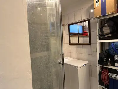 a glass shower in a bathroom with a toilet at Cozy place on the edge of Prague in Sibřina