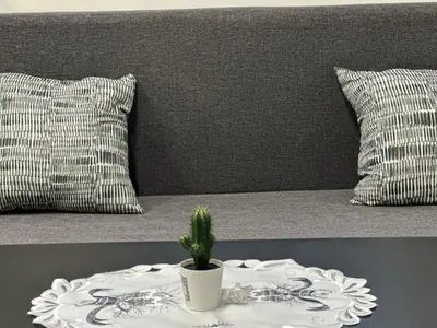 a table with a plate with a plant on top of a bed at Cozy place on the edge of Prague in Sibřina