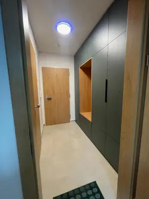 a hallway with a door and a room with cabinets at Newly built Studio in Prague Near Metro Haje in Prague