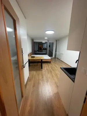an empty room with a bed in the middle of it at Newly built Studio in Prague Near Metro Haje in Prague